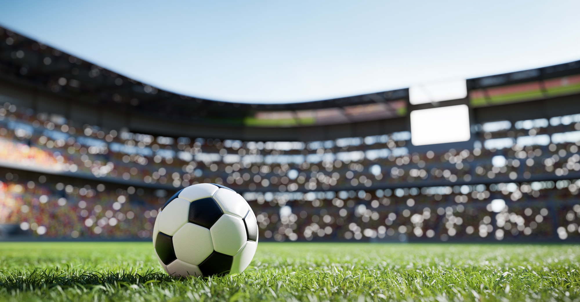 Football soccer ball on grass field on stadium
